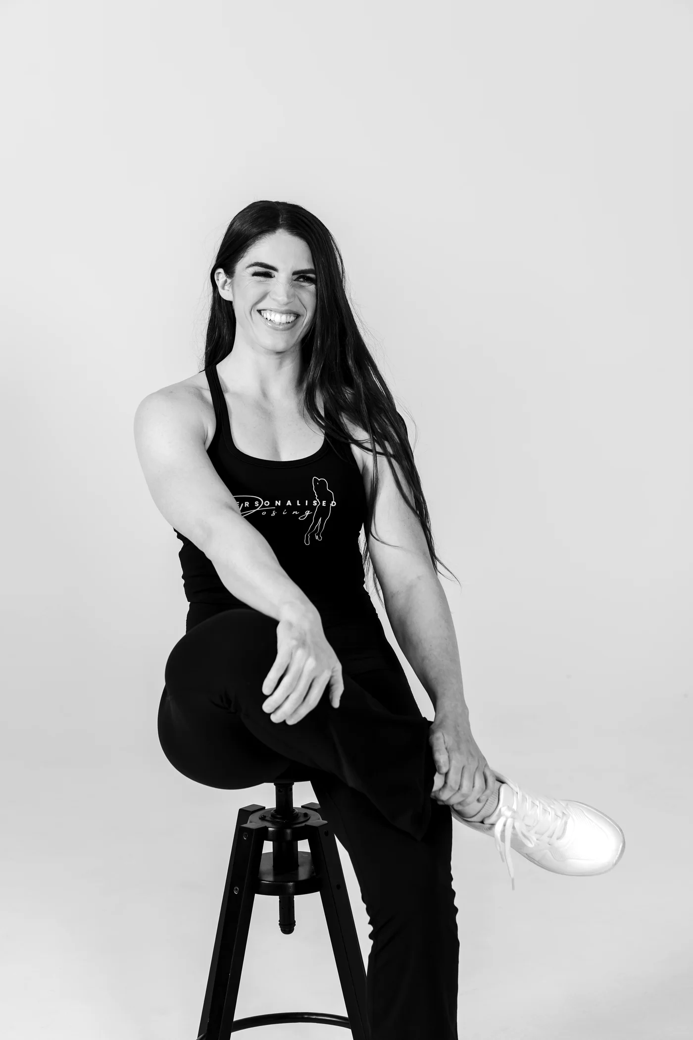 Georgia Voice seated on a studio stool, laughing